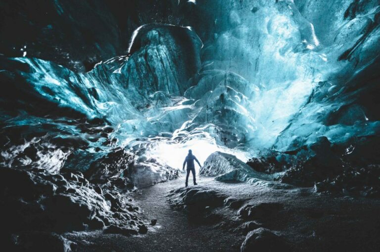 Katla Ice Cave, Ice Cave Tours, a man standing inside Katla Ice Cavel the best summer self driving tours in Iceland