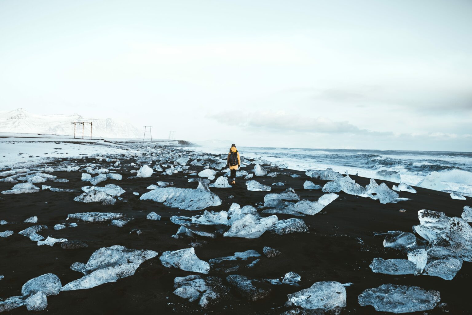 man walking on the Diamond Beach in south Iceland