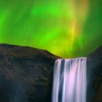 Northern lights at Skógafoss waterfall in Iceland