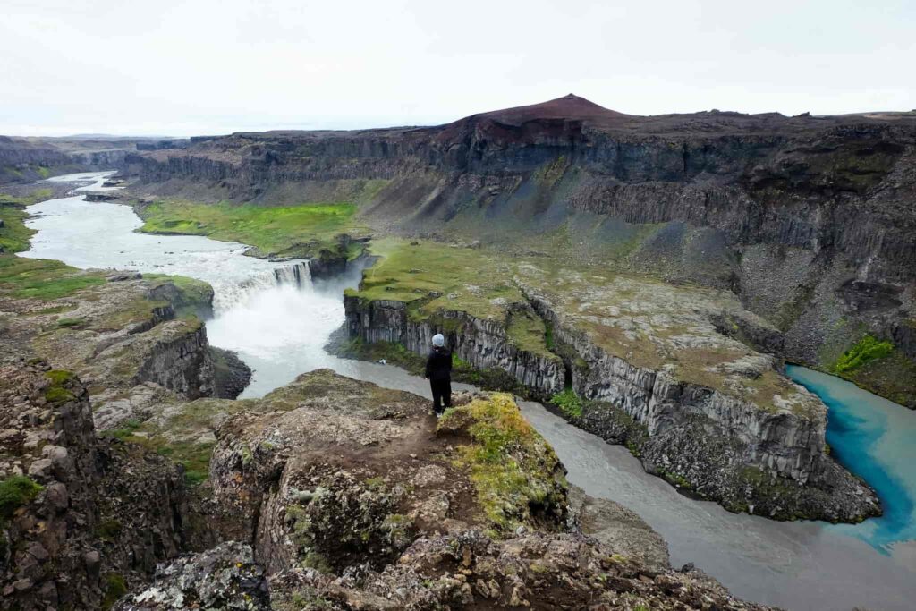 man standing on the viewpoint at Hafragilsfoss waterfall in the diamond circle in north Iceland