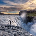 A powerful view of Dettifoss waterfall, the largest in Europe, located in North Iceland along the Diamond Circle route. The glacial waters cascade 45 meters into the rugged canyon below, surrounded by volcanic landscapes.