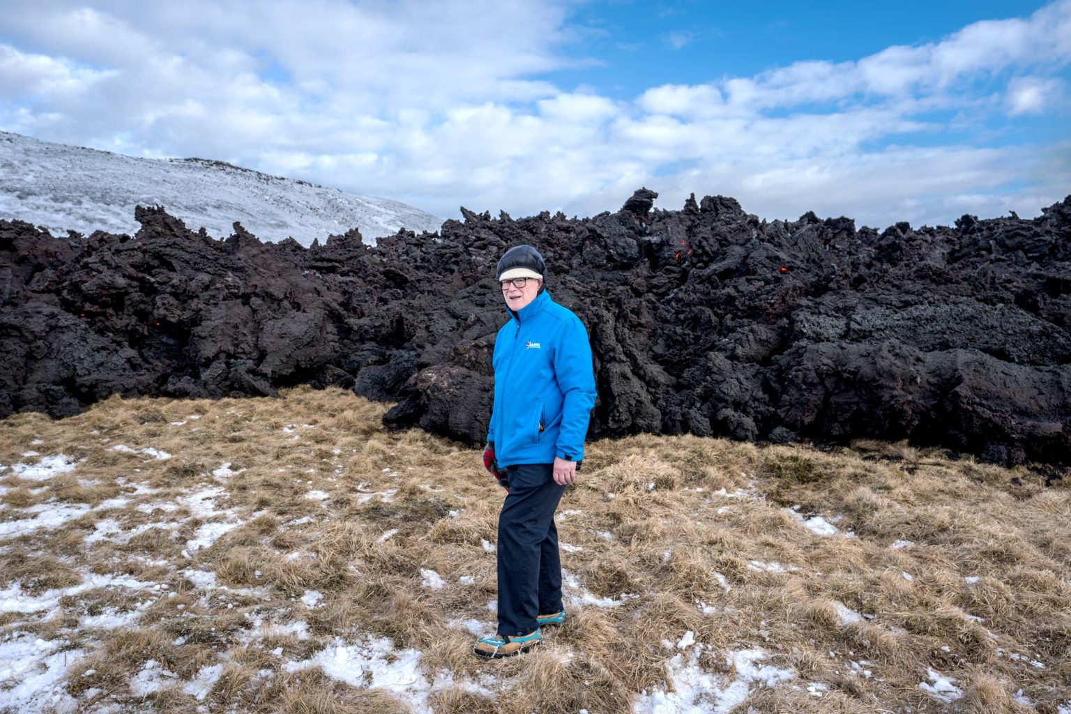 Man standing next to the recent volcano lava fields on Reykjanes Iceland