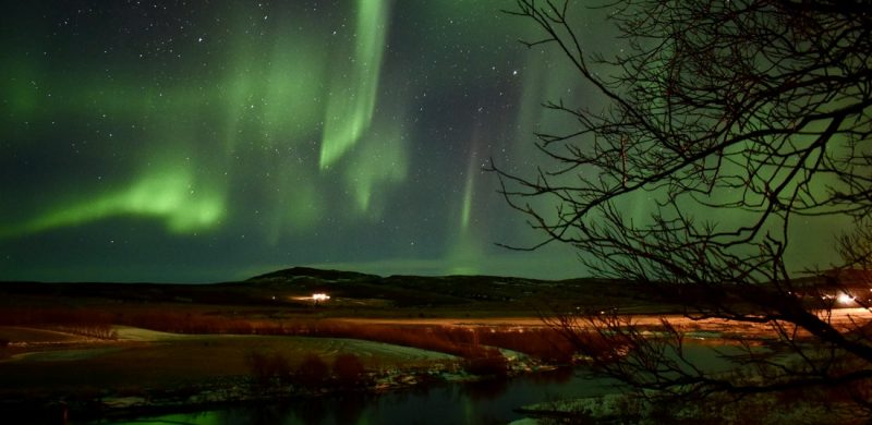 northern lights above Krauma natural baths in west Iceland